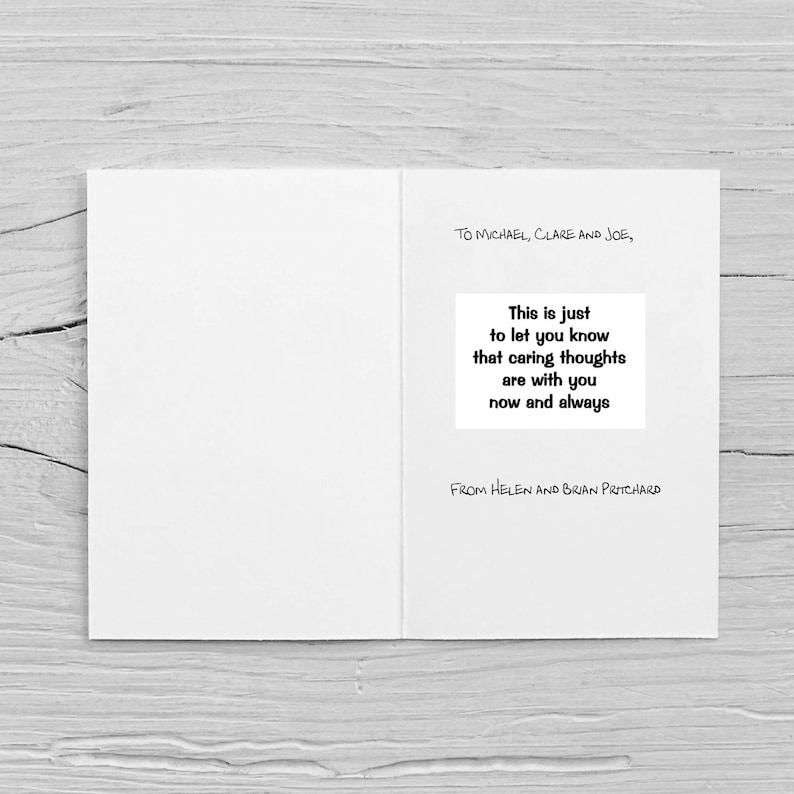 Op de afbeelding: Een open witte wenskaart met tekst. De kaart leest "TO MICHAEL, CLARE AND JOE," en bevat de boodschap "This is just to let you know that caring thoughts are with you now and always." De kaart is ondertekend met "FROM HELEN AND BRIAN PRITCHARD."