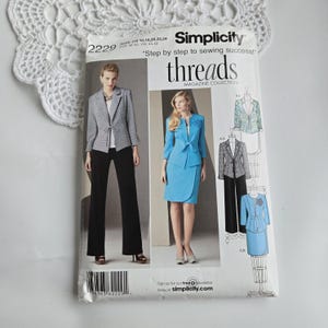 May include: Simplicity sewing pattern 2229, featuring images of women's suits. The pattern includes a blazer and pants, and a skirt suit. The text "threads MAGAZINE COLLECTION" is visible. The pattern size is US 16, 18, 20, 22, 24.