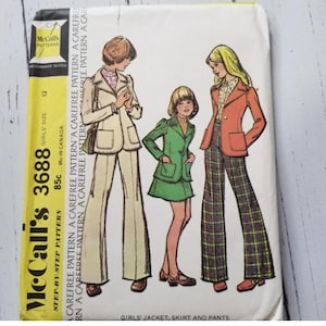 May include: Vintage McCall's 3688 sewing pattern for girls' jacket, skirt, and trousers. The illustration shows three figures wearing outfits in beige, green, and orange. The pattern includes the size 12 and is marked 85c and 95c in Canada.