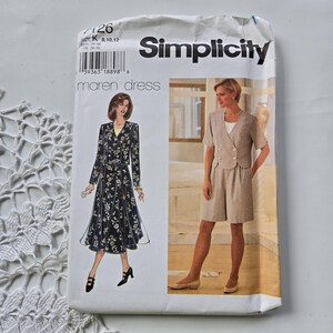 May include: A Simplicity sewing pattern envelope for the Maren dress, size K 8, 10, 12. The white paper envelope features illustrations of two outfits: a long-sleeved floral dress and a short-sleeved jacket with matching shorts in a light tan pattern.
