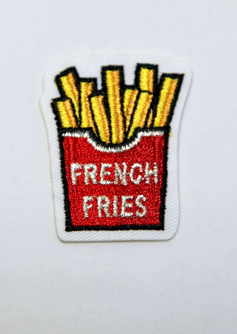 May include: An embroidered iron-on patch featuring a red and white box of french fries with the text "FRENCH FRIES" in white.