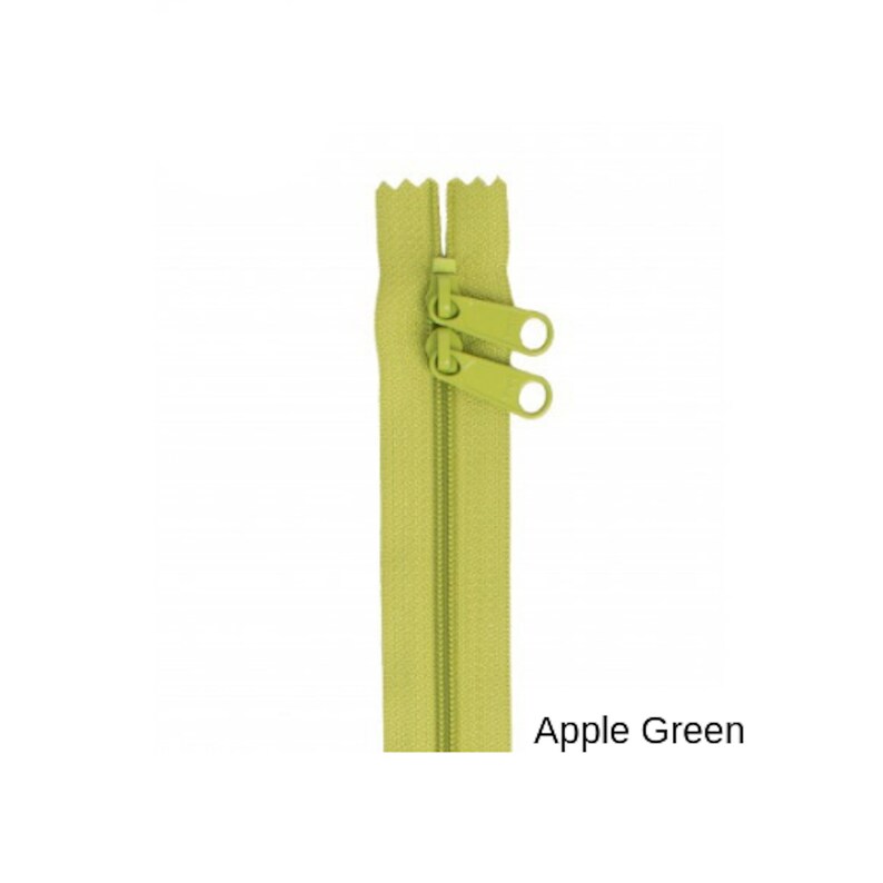 May include: A green zipper with two pull tabs. The zipper is closed and the pull tabs are at the top. The zipper is labeled "Apple Green".