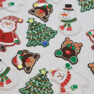 May include: Assortment of embroidered iron-on patches featuring Christmas themes, including Father Christmas, reindeer, snowmen, and Christmas trees. The patches are colourful and detailed, with a variety of festive designs.
