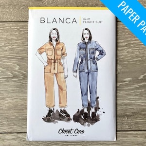 May include: A paper pattern for a jumpsuit called "Blanca Flight Suit" by Closet Core Patterns. The pattern shows two illustrations of women wearing the jumpsuit in different colours.