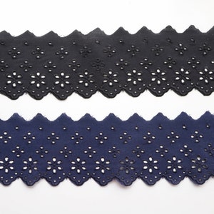 May include: Two pieces of black and navy blue cotton lace trim with a scalloped edge and a floral pattern.