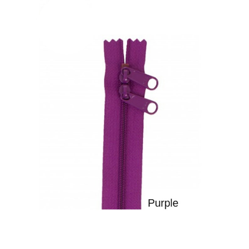 May include: Purple zipper with two pull tabs.