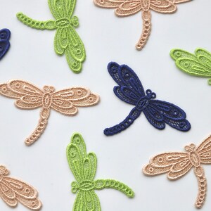 May include: Assortment of delicate lace dragonfly embellishments in green, beige, and blue. These decorative accents are perfect for adding a touch of whimsy to crafts, clothing, and home decor.