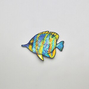May include: A blue and yellow fish with iridescent scales, embroidered with sequins. The fish is a popular motif for crafts and decorations.
