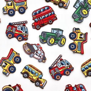 May include: A collection of colourful embroidered iron-on patches featuring various vehicles, including a school bus, fire engine, police car, tractor, and double-decker bus. The patches are perfect for adding a fun and whimsical touch to clothing, bags, or other fabric items.