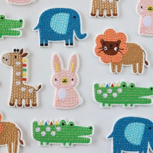 May include: A set of 10 colourful embroidered iron-on patches featuring various animals, including a giraffe, elephant, lion, crocodile, and rabbit. The patches are perfect for adding a playful touch to clothing, bags, or other fabric items.