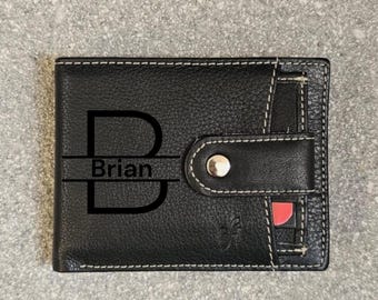 May include: Black leather wallet with a white stitch detail. The wallet has a flap with a snap closure and a card slot. The wallet is personalized with the letter "B" and the name "Brian" in black.