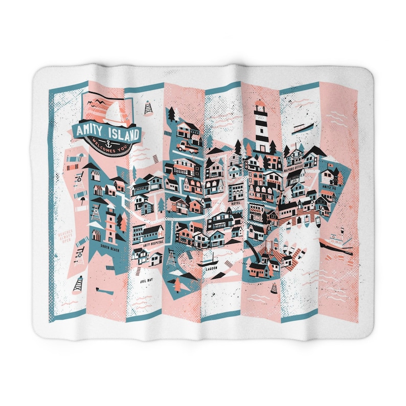 Op de afbeelding: Een gestileerde kaart van Amity Island, een fictieve stad uit de film Jaws. De kaart is in gevouwen stijl, met een blauw en roze kleurenschema. De kaart toont verschillende gebouwen, een vuurtoren en de tekst "Amity Island Welcomes You".