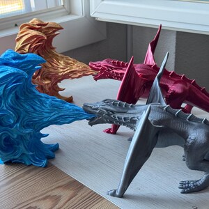 May include: Four dragon figurines, each with a different color and design. The dragons are made of plastic and are about 10 inches long. The dragons are arranged in a circle, with their heads facing each other.