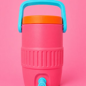 May include: A pink water cooler with an orange lid and a blue handle and tap. The cooler has vertical ridges around the middle and is designed to hold a large quantity of liquid. The cooler is designed for outdoor use.