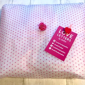 May include: A pink and white polka dot gift bag with a pink rose and a pink tag that says "LOVE LETTERS by Analise" with social media icons and usernames.