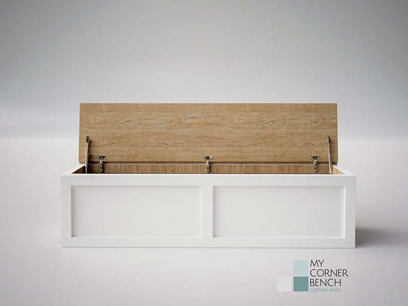 May include: A white storage bench with a light wood-grain lid that is partially open, revealing the interior. The bench has a rectangular shape with a clean, modern design. The bench is custom made.