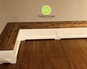May include: White corner bench with a wooden top. The bench has a storage compartment and is made by Habitat Concept, Custom Made Furniture.