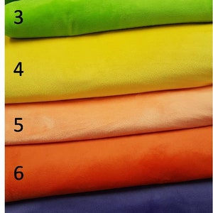 May include: Seven fabric swatches in different colours, stacked on top of each other. The swatches are numbered 1 through 7. The colours are green, lime green, yellow, peach, orange, purple, and blue.