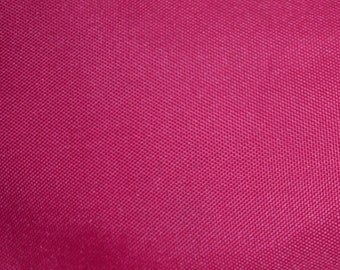 May include: Close-up of a deep pink fabric with a textured woven pattern.