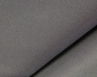 May include: Close-up of two pieces of gray fabric with a textured weave. The fabric is folded over, creating a diagonal line.