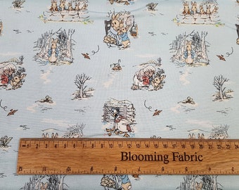 May include: Blue cotton fabric with a repeating pattern of Peter Rabbit characters. The fabric features Peter Rabbit, Benjamin Bunny, and other characters from the Beatrix Potter stories. The fabric is perfect for quilting, sewing, and crafting.