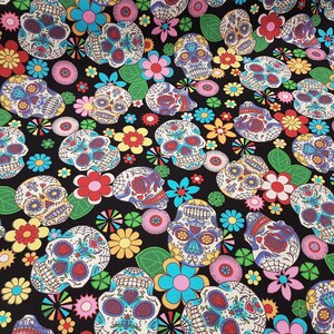 May include: Black fabric with a repeating pattern of colorful sugar skulls and flowers. The skulls are decorated with intricate designs and bright colors.