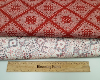 May include: Two pieces of fabric with a paisley bandana print. The top piece is red with white paisley, the bottom piece is white with red and blue paisley. A wooden ruler with the text "Blooming Fabric" is at the bottom of the image.