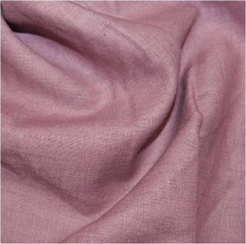 May include: A soft, textured fabric in a dusty rose color. The fabric has a subtle sheen and a slightly wrinkled appearance.