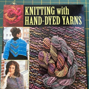 May include: Book cover with the title "Knitting with Hand-Dyed Yarns" and a photo of colorful yarn. The book features 20 stunning projects. The authors are Missy Burns, Stephanie Blaydes Kaisler, and Anita Tosten.