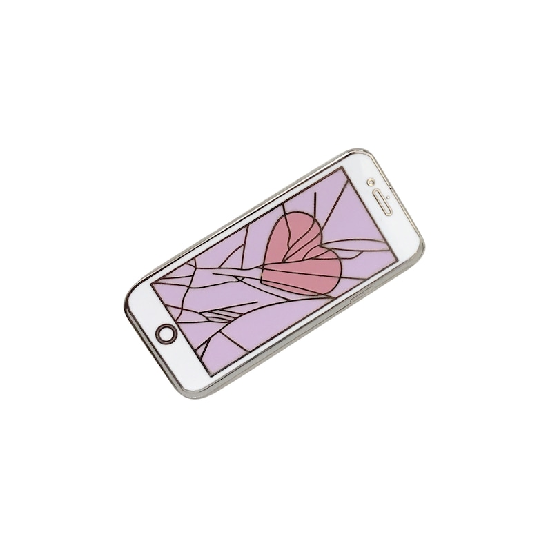 May include: A white smartphone with a cracked screen. The screen shows a pink heart on a purple background.