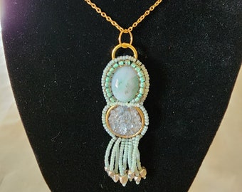Colgante: Cabujón de jade, chips de cidra, rocallas, borlas, detalles en plata, cadena de oro