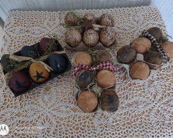 May include: A collection of decorative Easter eggs in various colors and patterns. Some eggs are painted with stars, while others have a speckled design. They are arranged in trays and baskets, with decorative accents.