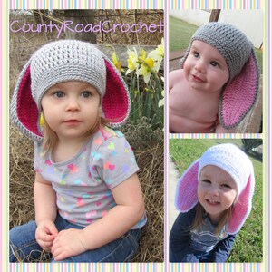 May include: Two children wearing crocheted bunny hats with pink ears. The hats are gray and white. The children are smiling and looking at the camera. The image is from County Road Crochet.