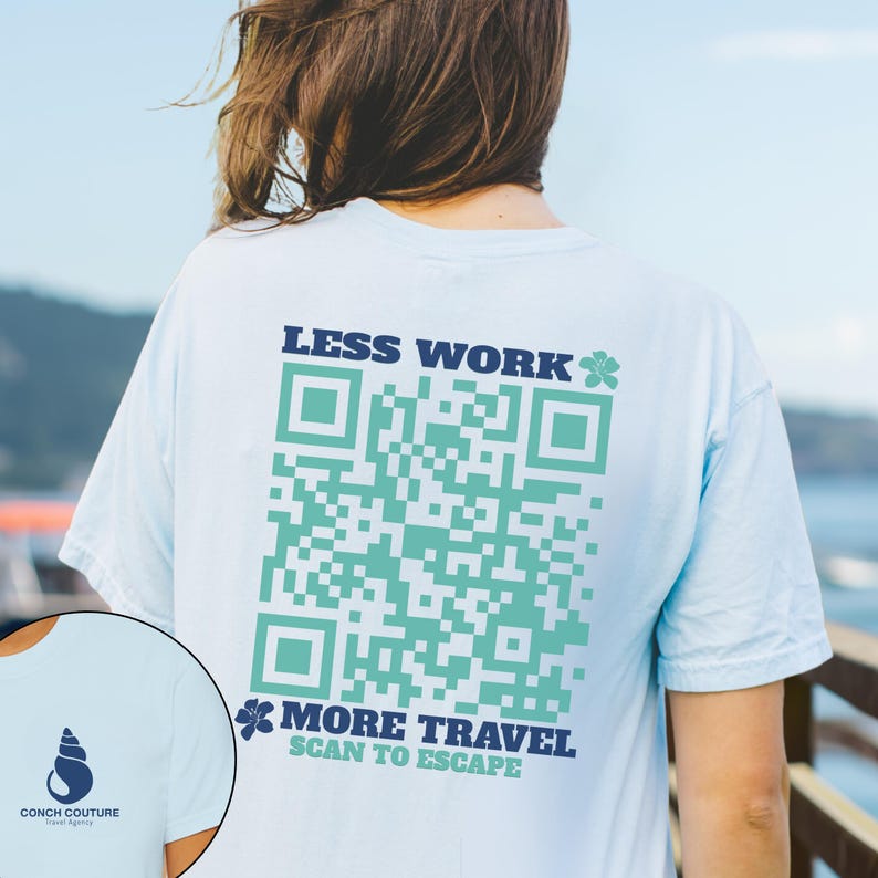 May include: Light blue t-shirt with a large QR code design in teal and the text "LESS WORK" and "MORE TRAVEL SCAN TO ESCAPE" in navy blue. The shirt also features a Conch Couture logo.