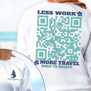 May include: White sweatshirt with a large teal QR code design on the back, accompanied by the text "LESS WORK MORE TRAVEL SCAN TO ESCAPE." A smaller image shows a Conch Couture logo on the front.