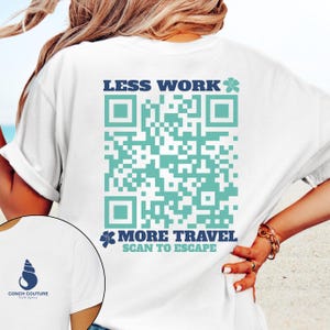 May include: White t-shirt with a blue logo of a seashell and the text "Conch Couture Travel Agency" on the front. The back features a large teal QR code with the text "LESS WORK MORE TRAVEL SCAN TO ESCAPE" in blue.