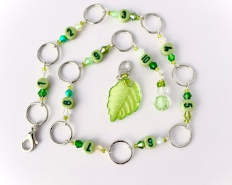 Row counter chain available with 8mm or 10mm diameter rings, leaf marker with green crystal beads