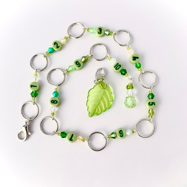 Row counter chain available with 8mm or 10mm diameter rings, leaf marker with green crystal beads