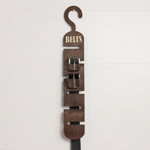 Rustic wooden belt hanger for men, handmade belt organizer with 3D BELTS letters, gift for him or dad
Wooden belt rack for closet organization, handmade gift for husband or boyfriend

Belt holder for wardrobe, wooden hanger with BELTS sign, men’s accessories organizer
Wooden belt hanger inside modern closet, space-saving belt organizer for men
Gift-ready wooden belt rack, rustic home accessory, perfect Father’s Day gift
Handmade plywood belt organizer, natural wood finish, functional men’s gift