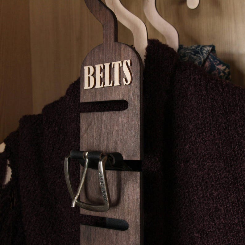 Rustic wooden belt hanger for men, handmade belt organizer with 3D BELTS letters, gift for him or dad
Wooden belt rack for closet organization, handmade gift for husband or boyfriend

Belt holder for wardrobe, wooden hanger with BELTS sign, men’s accessories organizer
Wooden belt hanger inside modern closet, space-saving belt organizer for men
Gift-ready wooden belt rack, rustic home accessory, perfect Father’s Day gift
Handmade plywood belt organizer, natural wood finish, functional men’s gift