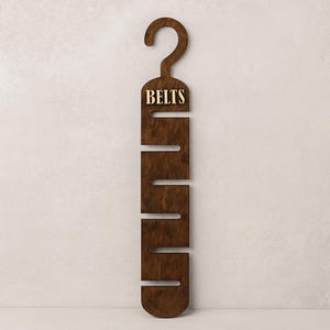 Rustic wooden belt hanger for men, handmade belt organizer with 3D BELTS letters, gift for him or dad
Wooden belt rack for closet organization, handmade gift for husband or boyfriend

Belt holder for wardrobe, wooden hanger with BELTS sign, men’s accessories organizer
Wooden belt hanger inside modern closet, space-saving belt organizer for men
Gift-ready wooden belt rack, rustic home accessory, perfect Father’s Day gift
Handmade plywood belt organizer, natural wood finish, functional men’s gift