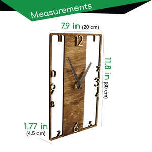 May include: A wooden wall clock with a brown wood grain finish and black hands. The clock is 7.9 inches wide, 11.8 inches tall, and 1.77 inches deep.