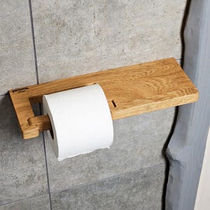 Modern Minimalist Wall-Mounted Wooden Holder
A sleek, modern wall-mounted toilet paper holder crafted entirely from wood. Its integrated storage shelf is perfect for keeping small bathroom essentials or even your phone. The smooth finish and clean lines make it an ideal addition to contemporary powder rooms while ensuring lasting durability.