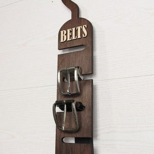 Rustic wooden belt hanger for men, handmade belt organizer with 3D BELTS letters, gift for him or dad
Wooden belt rack for closet organization, handmade gift for husband or boyfriend

Belt holder for wardrobe, wooden hanger with BELTS sign, men’s accessories organizer
Wooden belt hanger inside modern closet, space-saving belt organizer for men
Gift-ready wooden belt rack, rustic home accessory, perfect Father’s Day gift
Handmade plywood belt organizer, natural wood finish, functional men’s gift