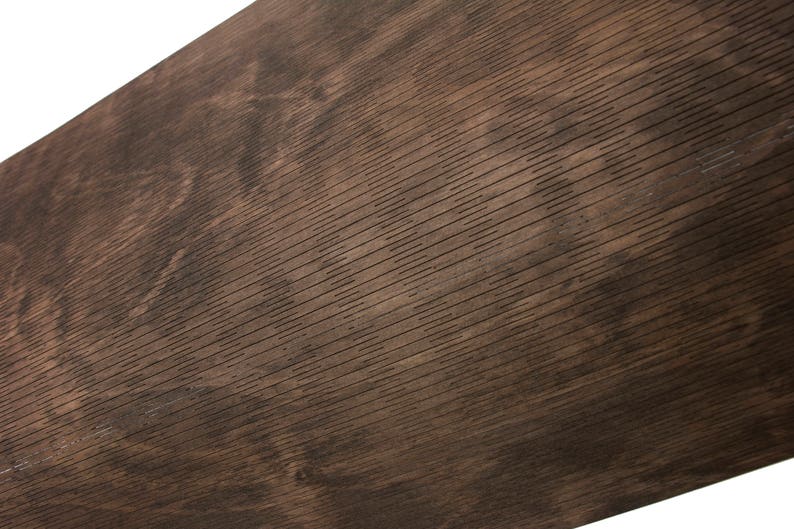 May include: Close-up of a dark brown wood grain surface with a textured pattern. The surface has a slightly rough feel and a natural, rustic look.