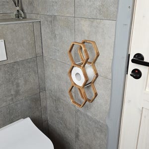 wall mounted toilet roll holder, handmade wood toilet paper rack, floating bathroom storage shelf, honeycomb TP dispenser, rustic wood bathroom shelf, toilet roll display, wooden tissue paper wall mount, farmhouse toilet rack, modern rustic toilet storage, hexagon wood shelf