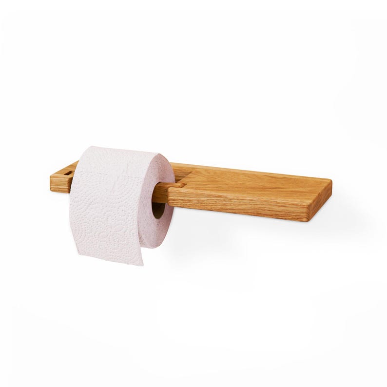 Reclaimed Wood Wall-Mounted Holder
Crafted from reclaimed wood, this eco-friendly toilet paper holder adds rustic charm and sustainable character to your bathroom. The unique texture and rich history of the wood create a one-of-a-kind piece that pairs well with both vintage and contemporary decor.