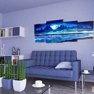 May include: A living room interior with a blue couch, a glass coffee table, and a multi-panel canvas painting depicting a seascape with a stormy sky and a calm ocean.