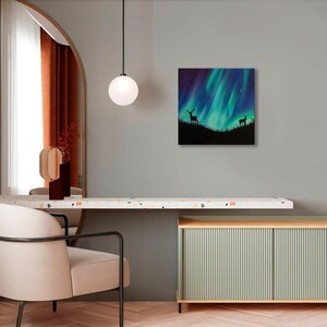 May include: A painting of a green and blue aurora borealis with two deer silhouettes in the foreground.