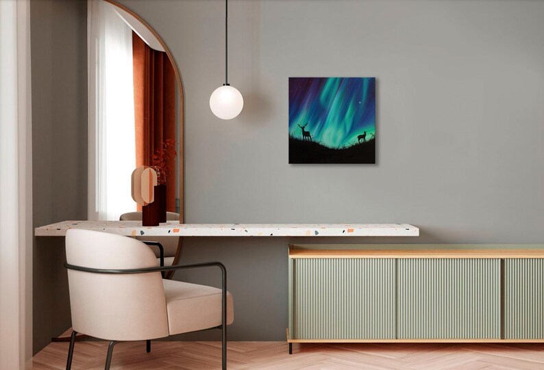 May include: A painting of a green and blue aurora borealis with two deer silhouettes in the foreground.